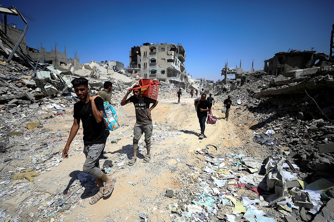 Palestinians make their way through the Shejaiya neighborhood in the eastern part of Gaza City July 10, 2024, inspecting the damage after Israeli forces withdrew following a ground operation amid the ongoing Israel-Hamas conflict. (OSV News photo/Dawoud Abu Alkas, Reuters)