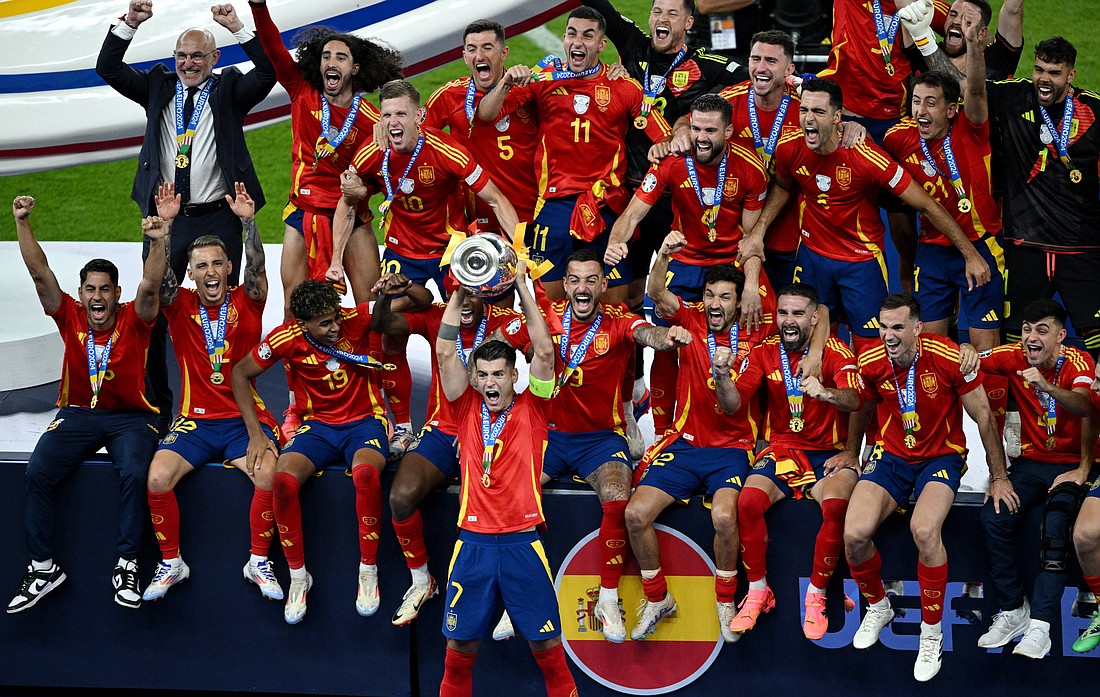 Spain's Alvaro Morata lifts the trophy as the national soccer team celebrates its 2-1 victory over England in European Championships July 14, 2024 in Berlin. Seen first in the upper left corner is Luis de la Fuente, the team's Catholic coach. Spanish bishops congratulated the team after winning, especially praising de la Fuente for not shying away from his faith and manifesting it throughout the tournament and daily life. (OSV News photo/Annegret Hilse, Reuters)