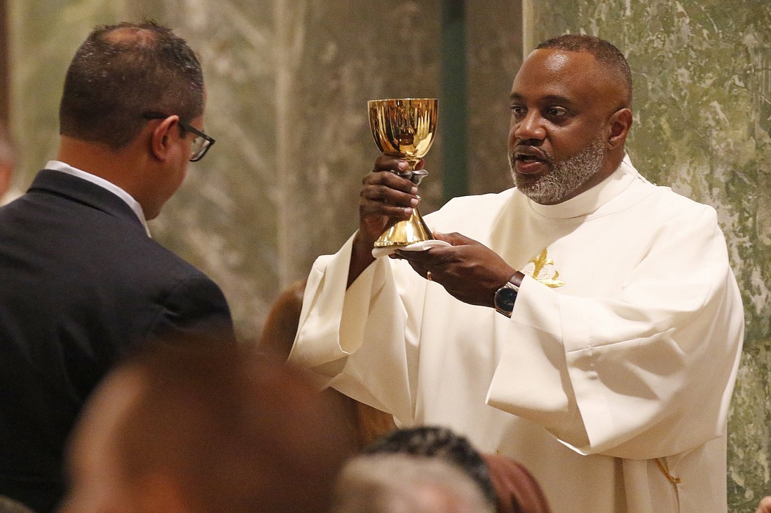 Deacon Rachid Murad offers the chalice to a communicant during his ordination to the diaconate at St. Joseph Co-Cathedral in Brooklyn, N.Y., May 25, 2019. (OSV News photo/CNS file, Gregory A. Shemitz)