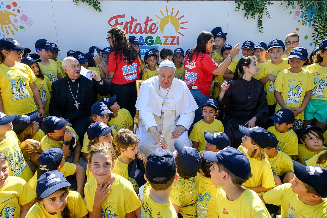 Pope Francis greets children of Vatican employees attending a summer camp at the Vatican July 18, 2024. Also in the photo are, to the pope's left, Cardinal Fernando Vérgez Alzaga, president of the commission governing Vatican City State, and, to the pope's right, Sister Raffaella Petrini, secretary-general of the commission and a member of the Franciscan Sisters of the Eucharist. (CNS photo/Vatican Media)