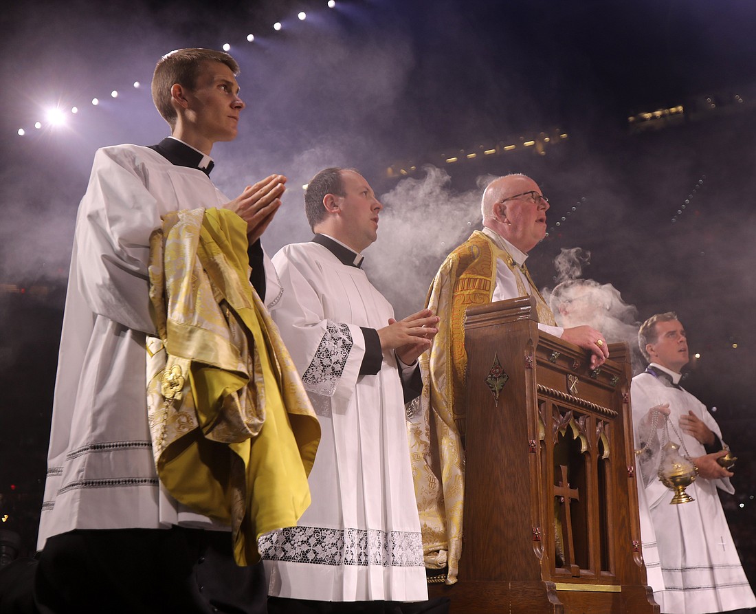 Bishop William D. Byrne of Springfield, Mass., kneels in prayer before the monstrance during Eucharistic adoration, at the second revival night of the National Eucharistic Congress at Lucas Oil Stadium in Indianapolis July 18, 2024. (OSV News photo/Bob Roller)