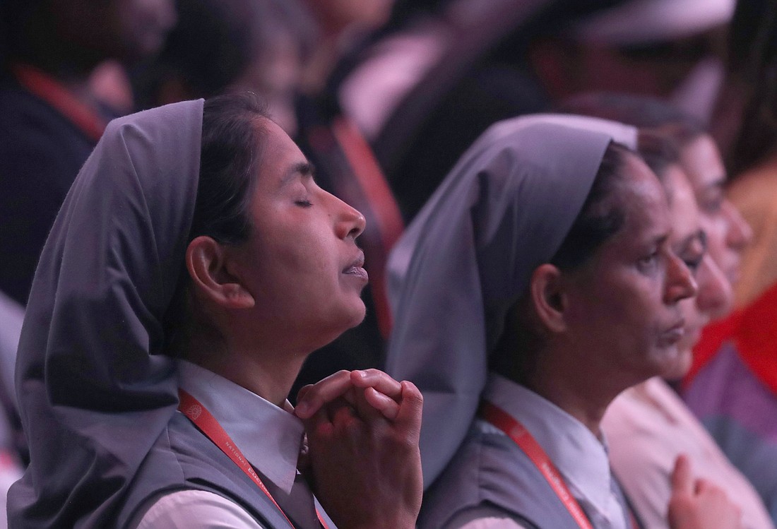 A religious sister prays during Holy Qurbana at Lucas Oil Stadium in Indianapolis July 20, 2024, during the National Eucharistic Congress. Holy Qurbana is the name for Mass in the Catholic Church's Syro-Malabar rite. (OSV News photo/Bob Roller)