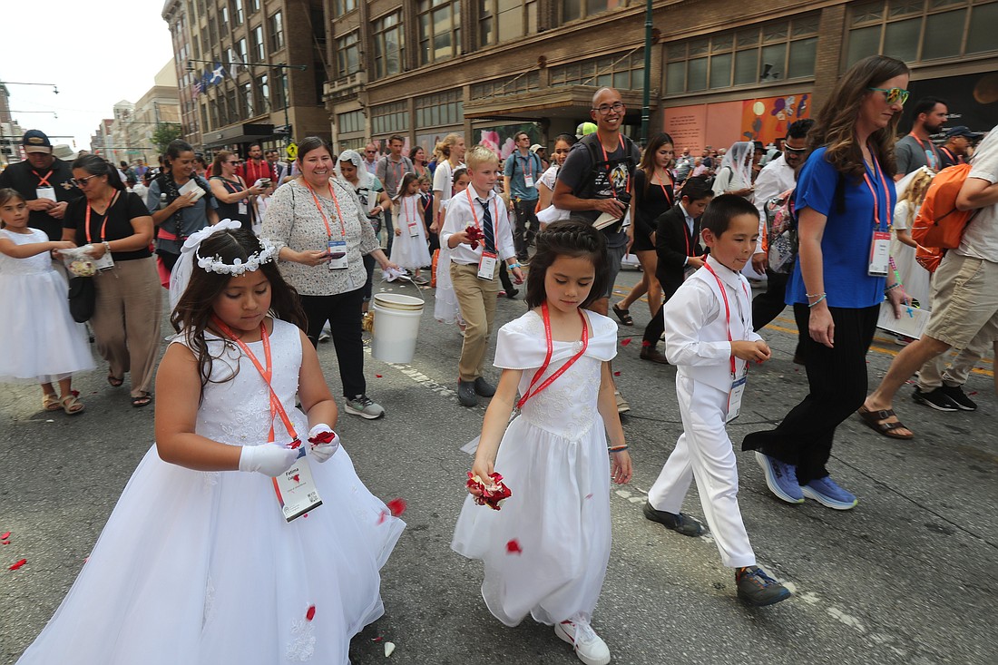 Young pilgrims throw rose petals during the final Eucharistic procession of the National Eucharistic Congress in downtown Indianapolis July 20, 2024. (OSV News photo/Bob Roller)