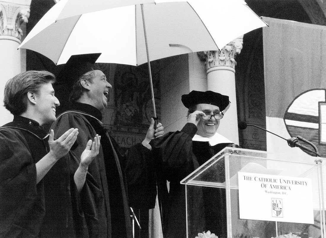 Comedian Bob Newhart cracks up Carmen Nanko and Father Robert Friday with a joke about the rain falling on the graduation ceremony May 21,1997 at The Catholic University of America. (OSV News photo/Catholic University of America, CNS archive)