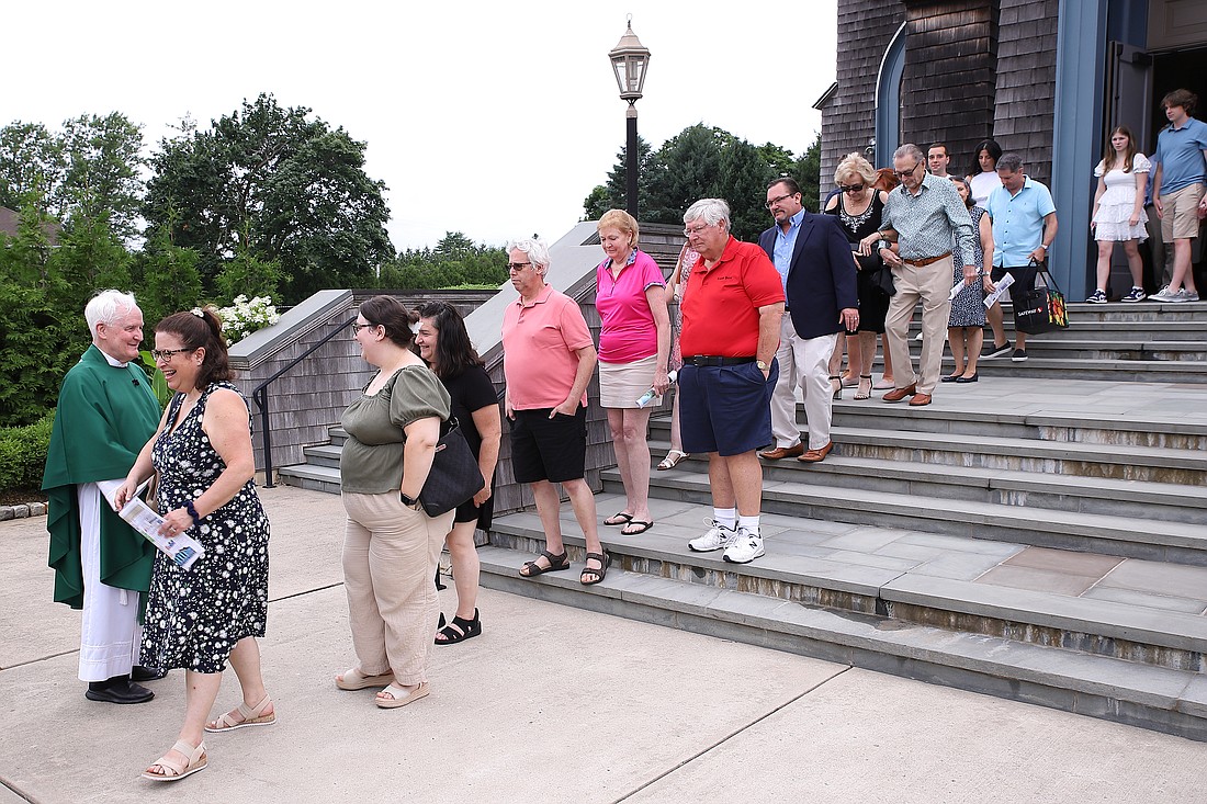 A long line of parishioners wait to greet Father Manning and wish him well on his retirement. John Batkowski photo