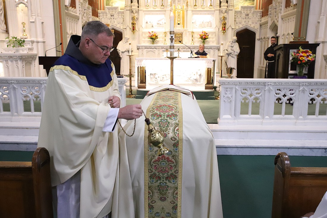 Father Michael Heine incenses the casket of Father Curtis Kreml during the July 26 Mass of Christian Burial celebrated in St. Peter Church, Point Pleasant Beach. John Batkowski photo