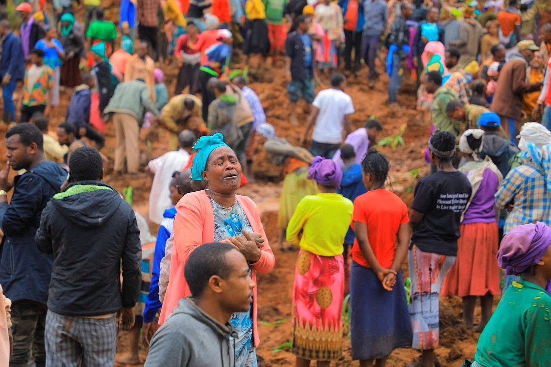 A woman reacts as residents dig July 23, 2024, to recover the dead bodies of victims of the landslide July 22 following heavy rains that buried people in the Gofa Zone in Southern Ethiopia state. (OSV News photo/Gofa Zone Government Communication Affairs Department Handout via Reuters)