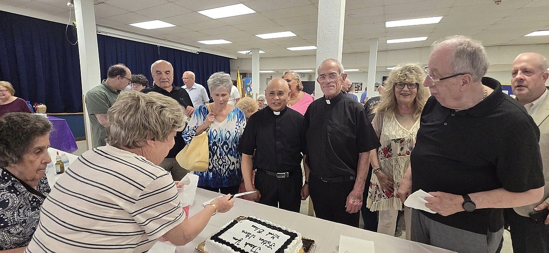 Father Gene Dagulpo and the parishioners of St. Raphael-Holy Angels Parish hosted a farewell Mass and celebration for Father Steve on July 7. Father Schuler lived in residence in the Hamilton parish. Facebook photo.