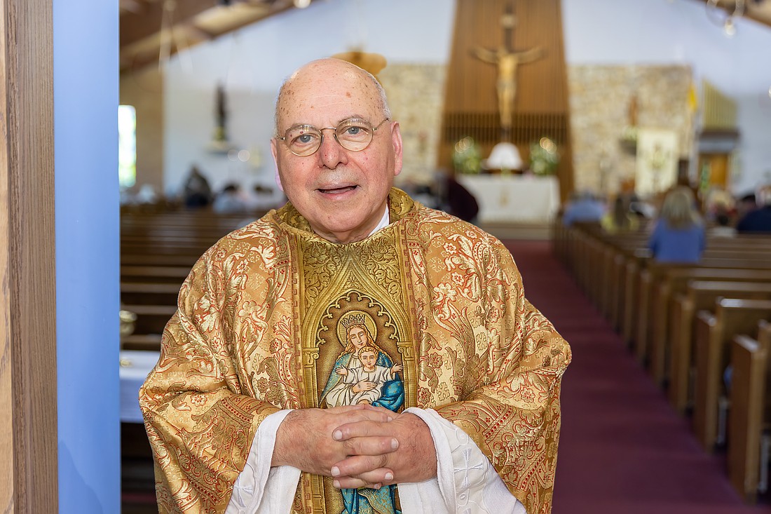 Father Papalia stands by the entrance to St. Elizabeth Ann Seton Church, Whiting, at the start of his 50th anniversary Mass of Thanksgiving. Hal Brown photo