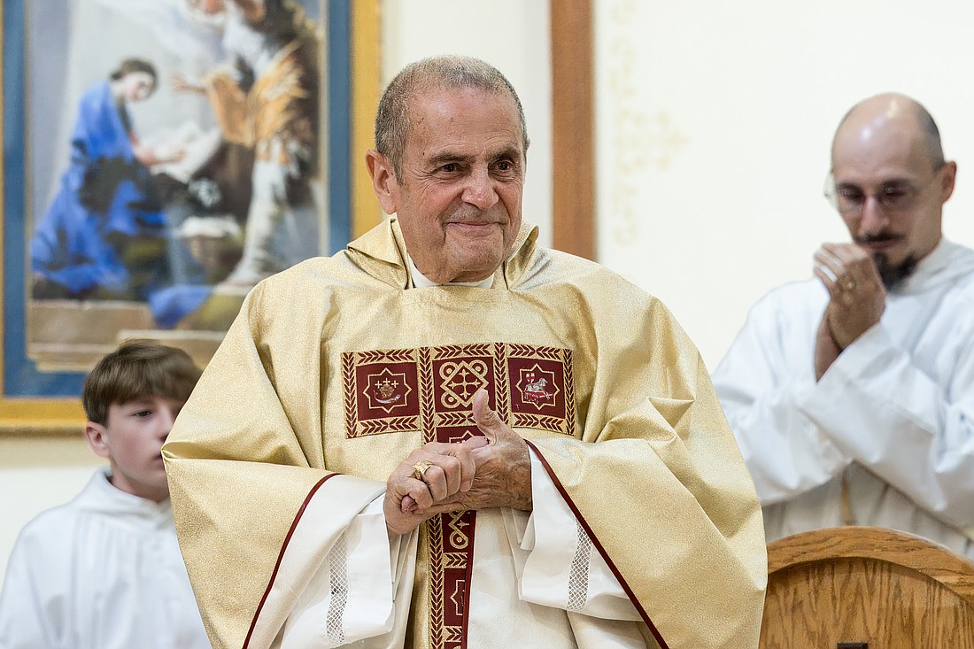 Father John T. Folchetti smiles during the June 30 Mass he celebrated for his golden jubilee of priesthood. Hal Brown photos