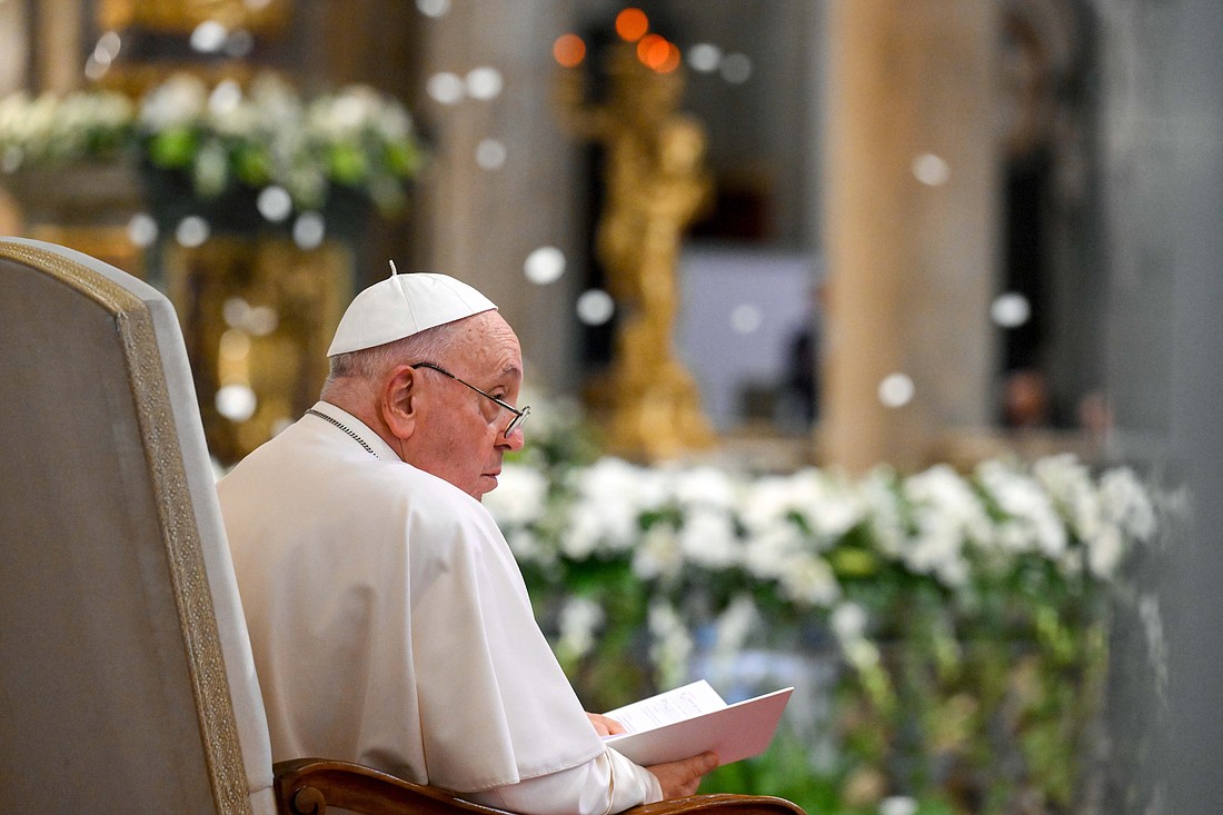 Pope Francis looks up while white rose petals fall from the ceiling of Rome's Basilica of St. Mary Major Aug. 5, 2024, during evening prayer on the feast of the basilica's dedication. According to tradition, on Aug. 5, 358, Mary had snow fall to mark the spot on Rome's Esquiline Hill where she wanted a church built in her honor. (CNS photo/Vatican Media)