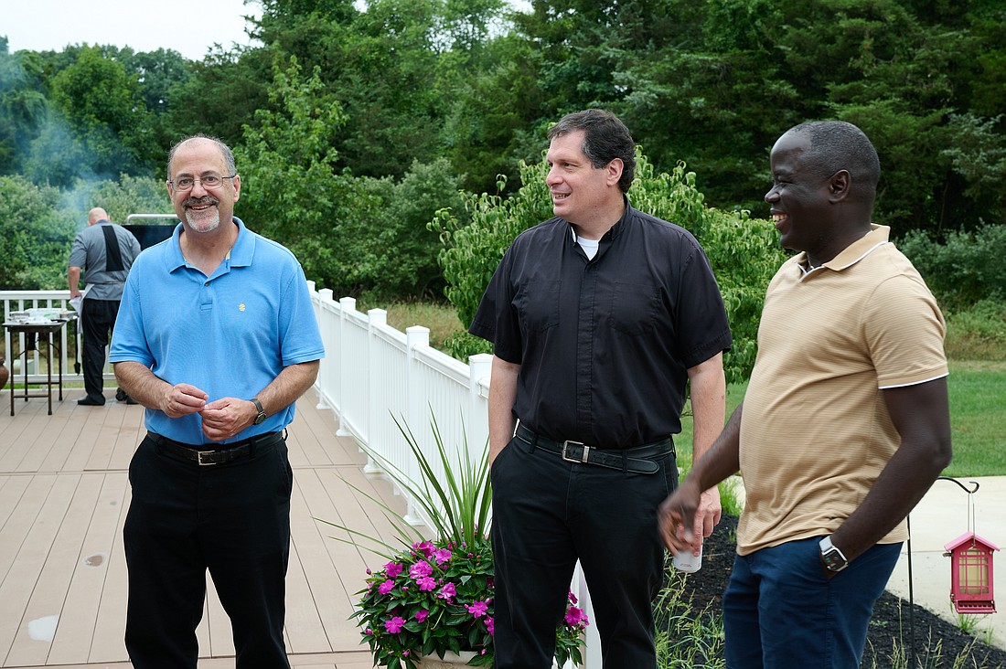 Father Thomas Vala, pastor of St. Clement Parish, Matawan; Father Christopher Picollo, pastor of Nativity Parish, Fair Haven, and Father Jean Felicien, secretary and master of ceremonies to Bishop O'Connell, enjoy conversation at the barbecue. Mike Ehrmann photo