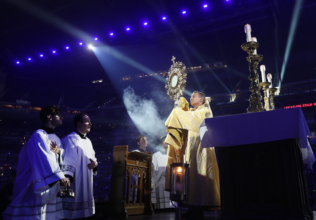 Bishop Andrew H. Cozzens of Crookston, Minn., chairman of the board of the National Eucharistic Congress, Inc., blesses pilgrims during adoration at the opening revival night of the 10th National Eucharistic Congress at Lucas Oil Stadium in Indianapolis July 17, 2024. (OSV News photo/Bob Roller)