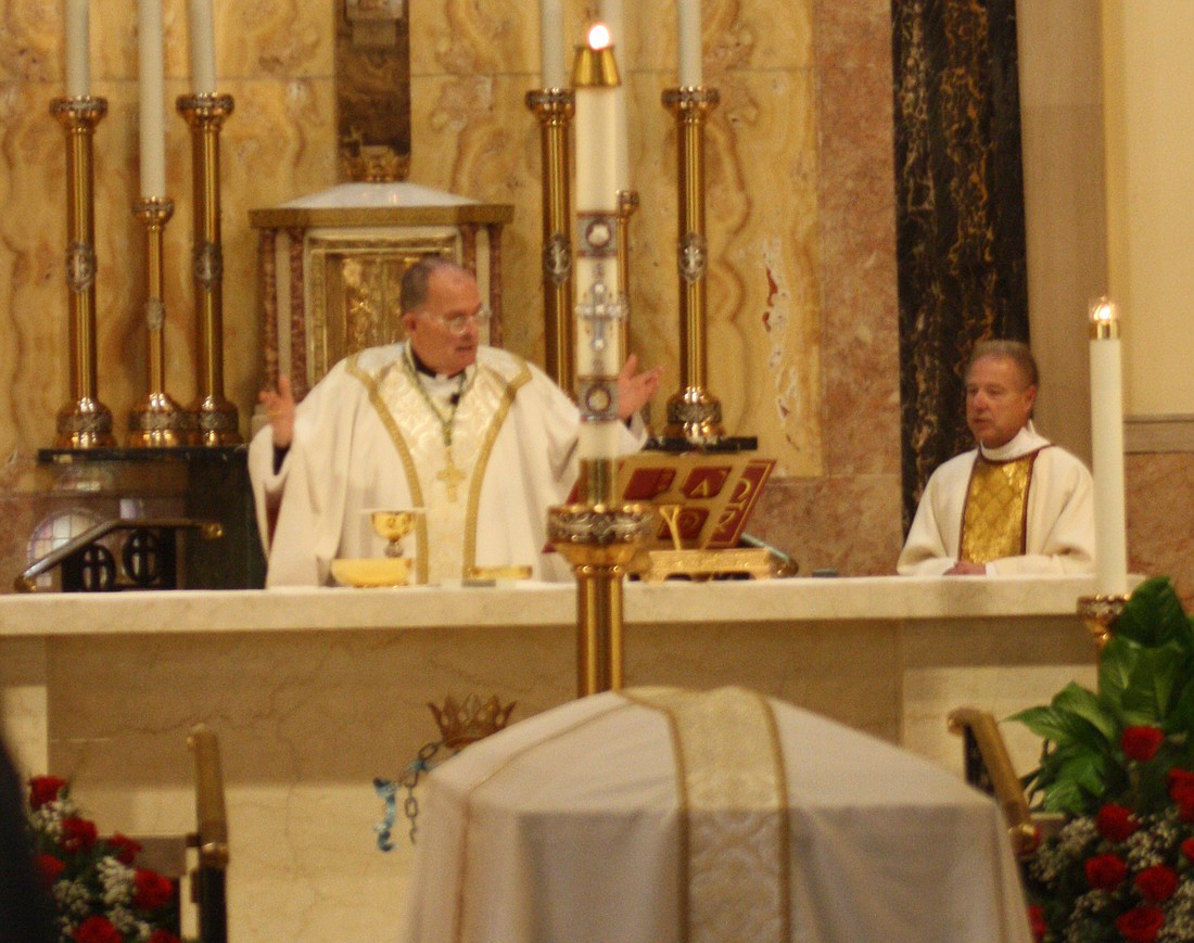 Bishop O'Connell celebrates the Mass of Christian Burial for RoseAnna Romanello who died Aug. 3. Mrs. Romanello was a longtime member of St. James Parish, Trenton, which went on to become part of Incarnation-St. James Parish, Ewing. At right is Trinitarian Father Stan DeBoe, parish pastor. Carol Olivieri photo