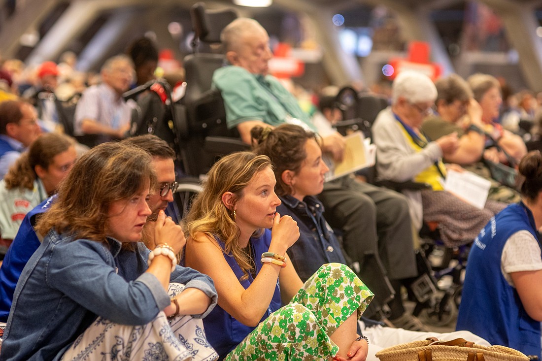 Pilgrims pray during the opening Mass of the French national pilgrimage to the Lourdes Sanctuary Aug. 12-16, 2024. The sanctuary's baths that draw pilgrims for their healing properties have fully reopened after being closed four years ago at the start of the pandemic when bathing was forbidden. Traditionally, pilgrims help and accompany the disabled, sick and frail so that they can experience their pilgrimage with the help of others. (OSV News photo/courtesy Lourdes Sanctuary)