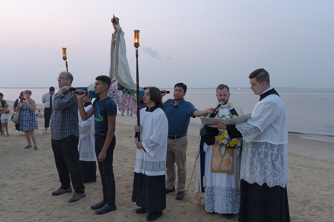 Father Rick Osborn leads a Blessing of the Water prayer service at a by near St. Catherine Laboure Parish, Middletown, Aug. 15. The blessing took place after Mass was celebrated in the church for the Solemnity of the Assumption of the Blessed Virgin Mary on August 15. Matt Marzorati photo