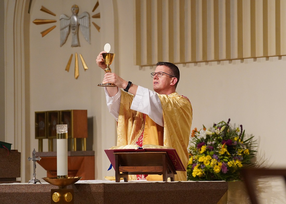 Father Joseph Fitzgerald, pastor of St. William the Abbot Church in Seaford, N.Y., elevates the chalice during Mass at his parish Jan. 27, 2021. The former Olympian, who served as chaplain at the 2024 Olympics in Paris, told OSV News the Catholic Church in the U.S. needs to prepare now to evangelize the 2028 Olympic and Paralympic Games in Los Angeles. (OSV News photo/Gregory A. Shemitz)