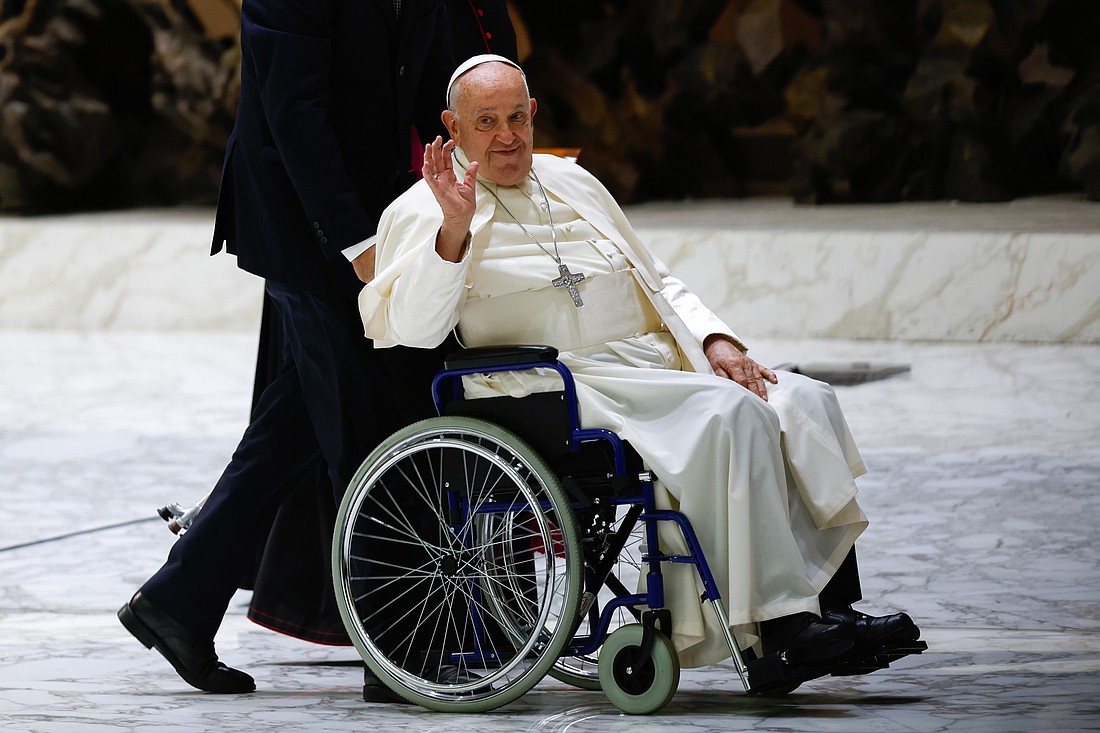 Pope Francis greets visitors as he leaves the Paul VI Audience Hall at the end of his weekly general audience at the Vatican Aug. 21, 2024. (CNS photo/Lola Gomez)