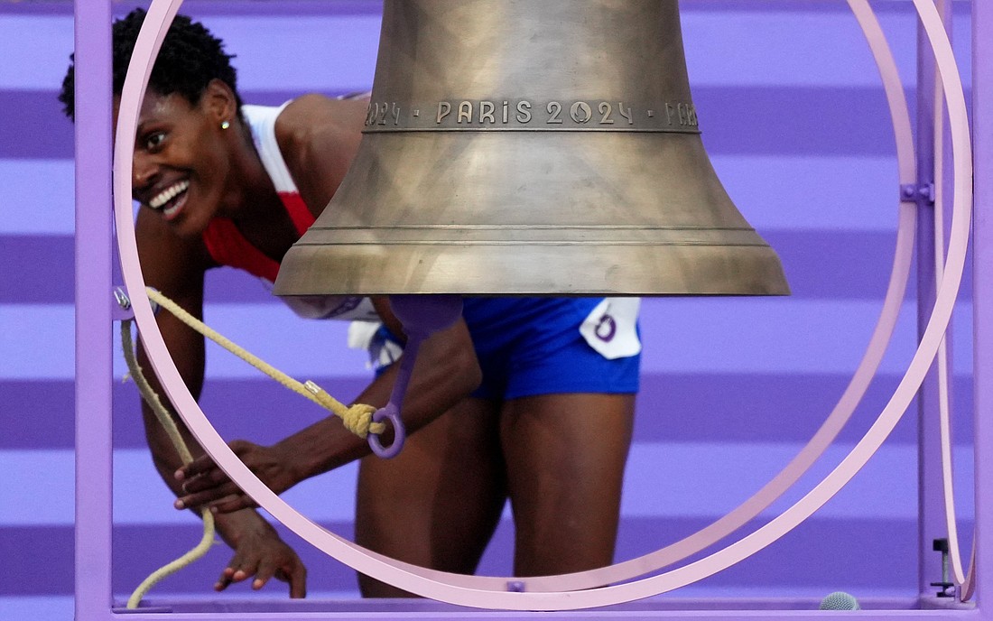 Marileidy Paulino of the Dominican Republic rings the Olympic bell Aug. 10, 2024, as she celebrates after winning gold and setting a new Olympic record in the women's 400-meter final during the 2024 Paris Olympics. The bell, specially cast for the Games by France's Cornille Havard foundry in Normandy, will be placed inside the newly restored Notre Dame Cathedral in Paris during every Mass once the cathedral officially reopens in December. (OSV News photo/Aleksandra Szmigiel, Reuters)