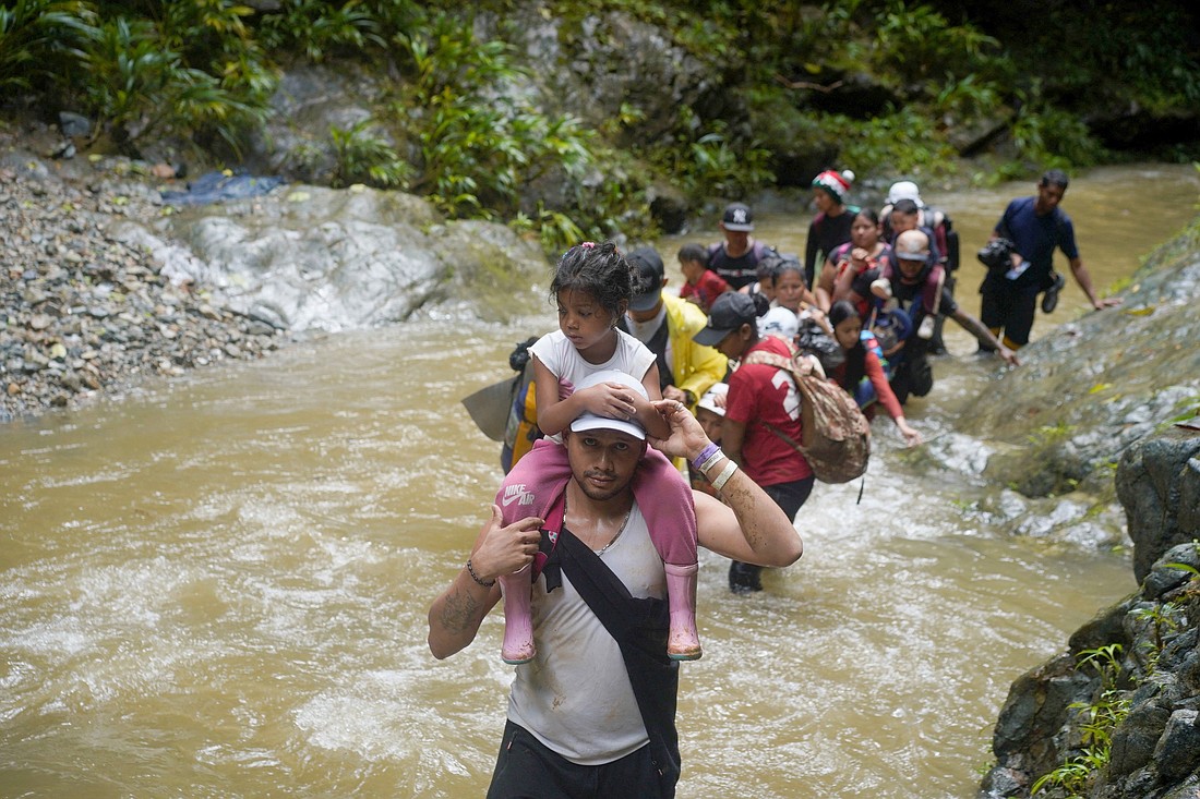 Migrants wade through water as they continue their their trek toward the Darién Gap in Acandi, Colombia, July 9, 2023. Considered one of the world's most dangerous migration routes, the Darién Gap is on the border between Colombia and Panama and consists of more than 60 miles of dense rain forest, steep mountains and vast swamps. (OSV News photo/Adri Salido, Reuters)