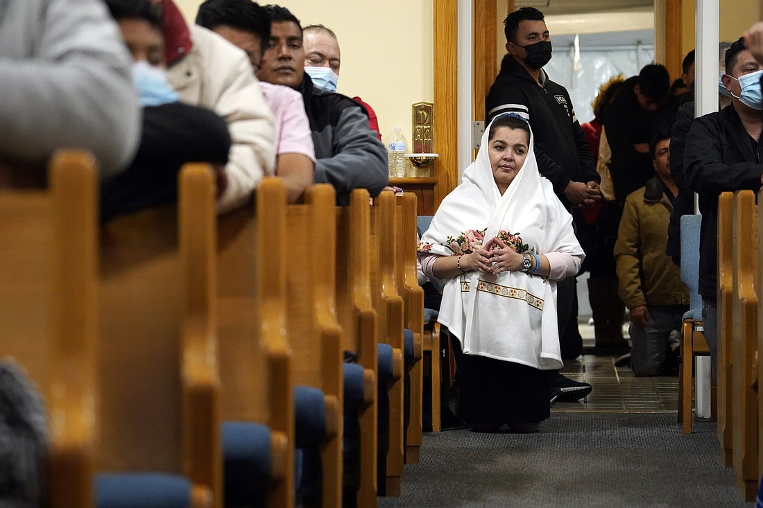 A woman kneels in an aisle while attending a Spanish-language Mass marking the feast of Our Lady of Guadalupe at Resurrection Church in Farmingville, N.Y., Dec. 12, 2021. Our Lady of Guadalupe is the patroness of Mexico, the Americas and the unborn. Eighty percent of Resurrection's parishioners are people of Mexican ancestry. (OSV News photo/Gregory A. Shemitz)