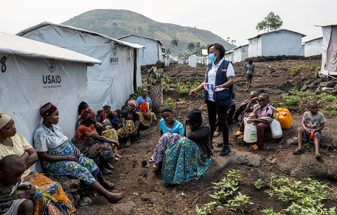 Nathalie Kipenzi, a hygiene promoter, talks to displaced people during an awareness campaign for mpox Aug. 19, 2024, at the Muja camp for the internally displaced near Goma, Congo. The infectious disease is caused by the mpox virus and results in a painful rash, enlarged lymph nodes and fever. (OSV News photo/Arlette Bashizi, Reuters)