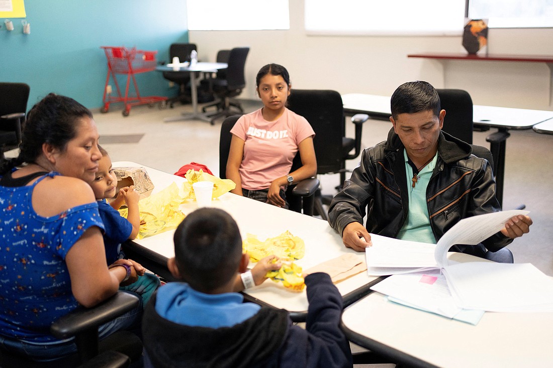 A migrant from Chiapas, Mexico, looks through his family's immigration paperwork at Casa Alitas in Tucson, Ariz., March 15, 2024. A federal judge in Texas Aug. 26, halted a Biden administration program that gives a pathway to legalization and citizenship for certain undocumented spouses and children of U.S. citizens. (OSV News photo/Rebecca Noble, Reuters)