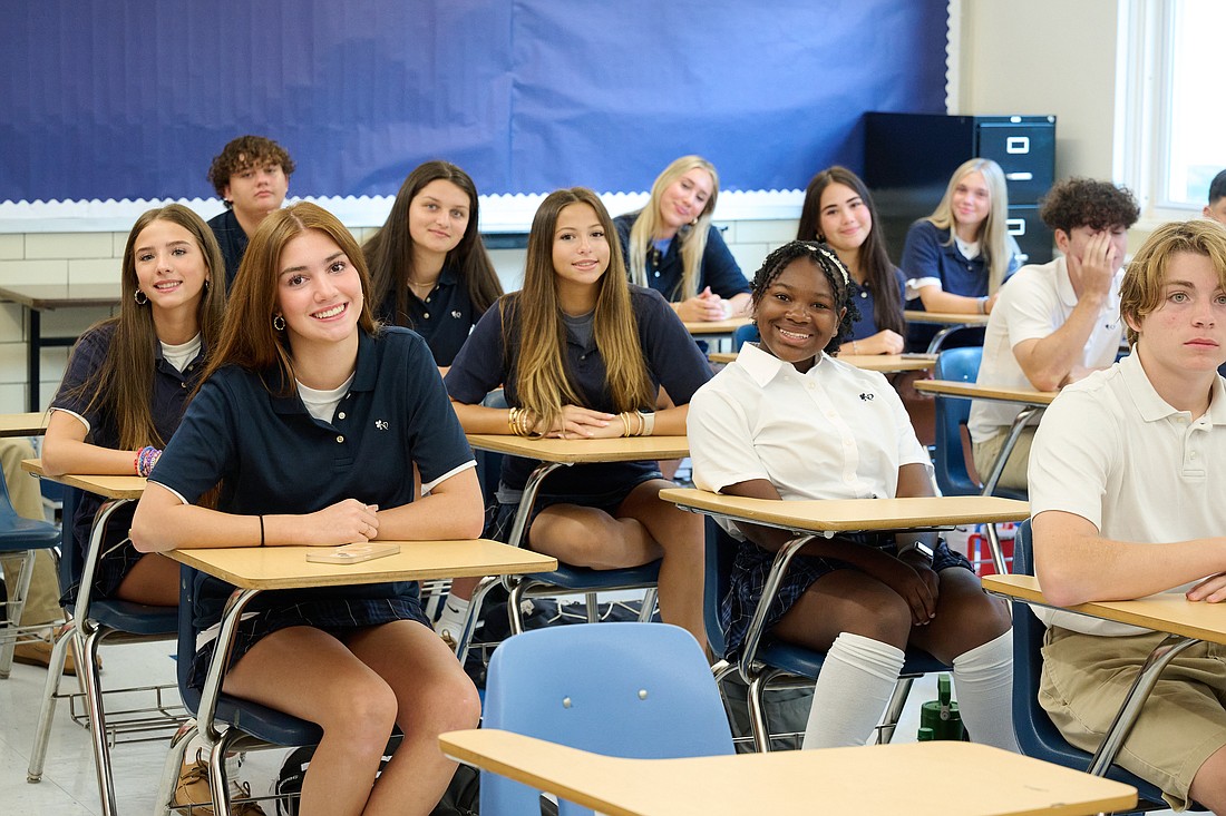 Eager to begin, students of Notre Dame High School, Lawrenceville, smile for a photo in their first class of the new academic year Aug. 29. Mike Ehrmann photo