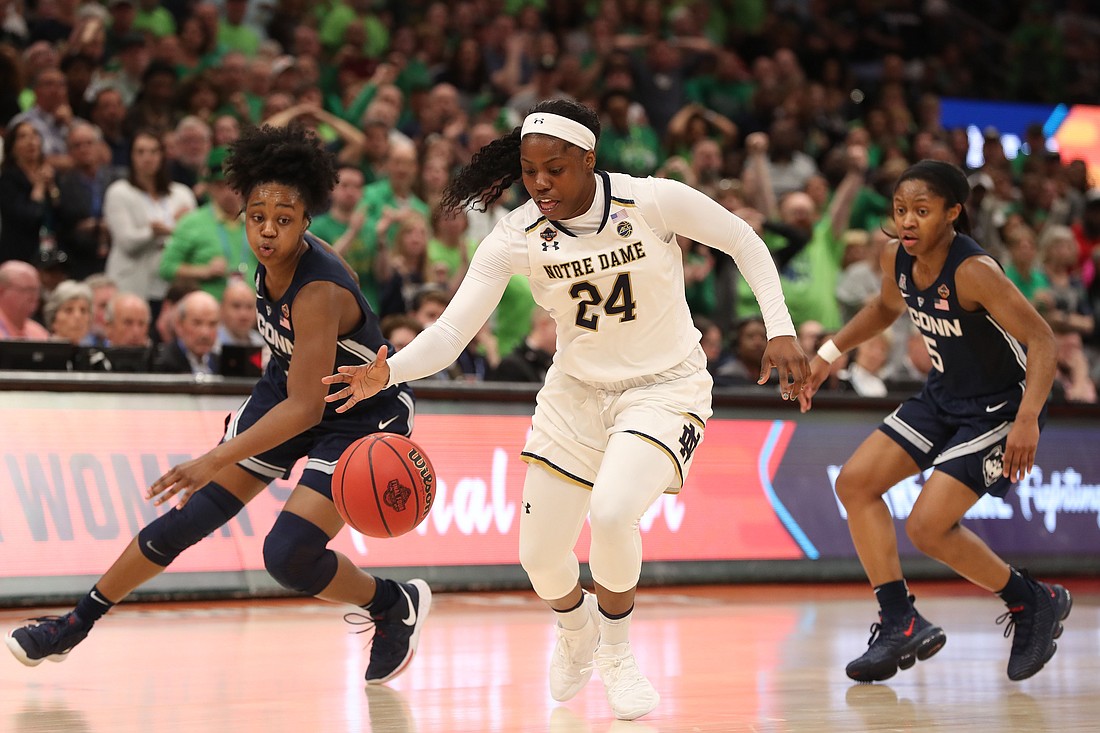 Arike Ogunbowale of the University of Notre Dame controls the ball in front of University of Connecticut players Christyn Williams and Crystal Dangerfield during the semifinals of the women's Final Four of the 2019 NCAA Tournament in Tampa, Fla. OSV News photo/Kim Klement-USA TODAY Sports via Reuters