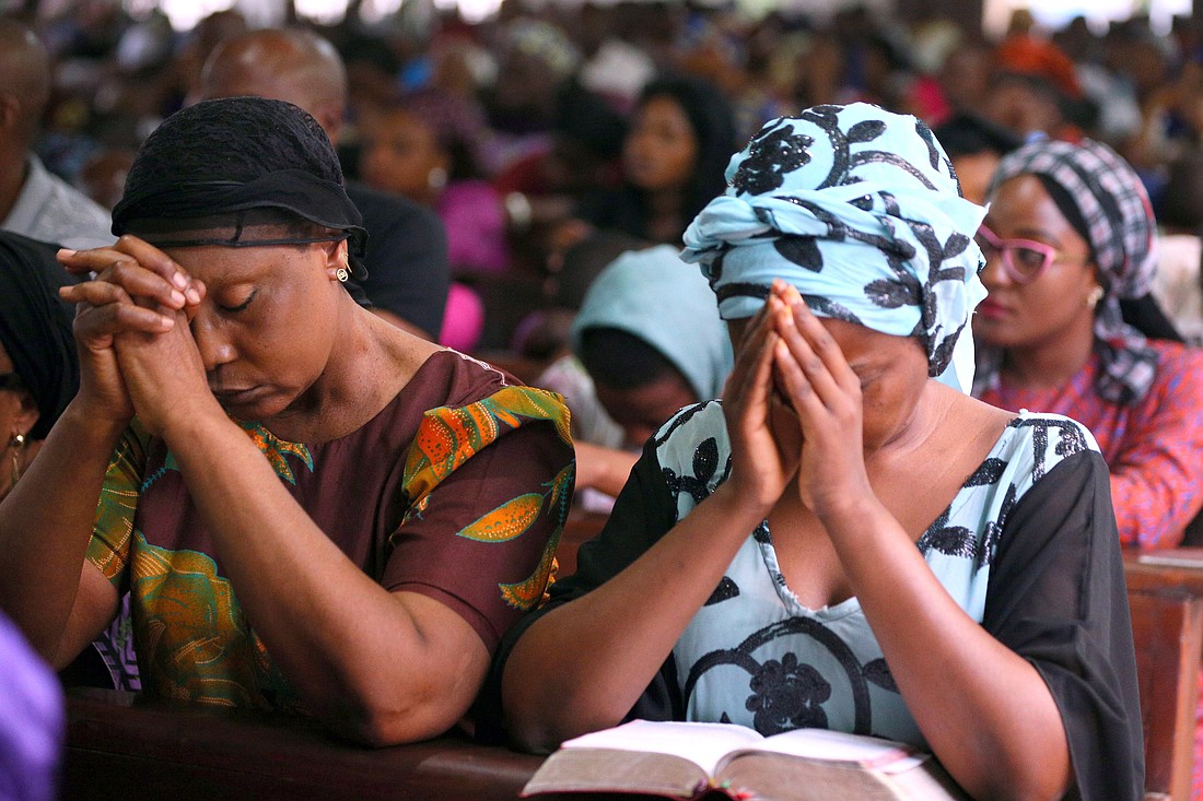 A woman is pictured in a file photo praying during Mass at Holy Rosary Catholic Church in Abuja, Nigeria. (OSV News photo/Afolabi Sotunde, Reuters)