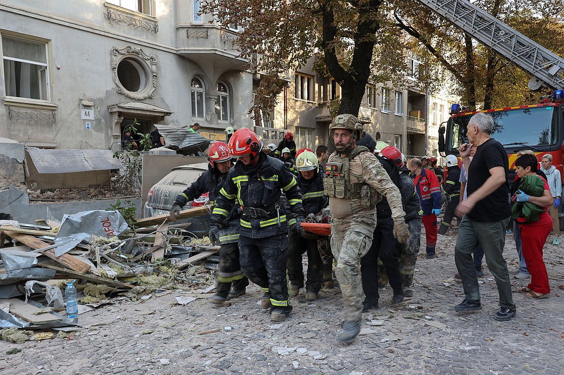 Emergency workers carry the body of a person killed during a Russian drone and missile strike Sept. 4, 2024, on residential buildings in Lviv, Ukraine. (OSV News photo/Roman Baluk, Reuters)