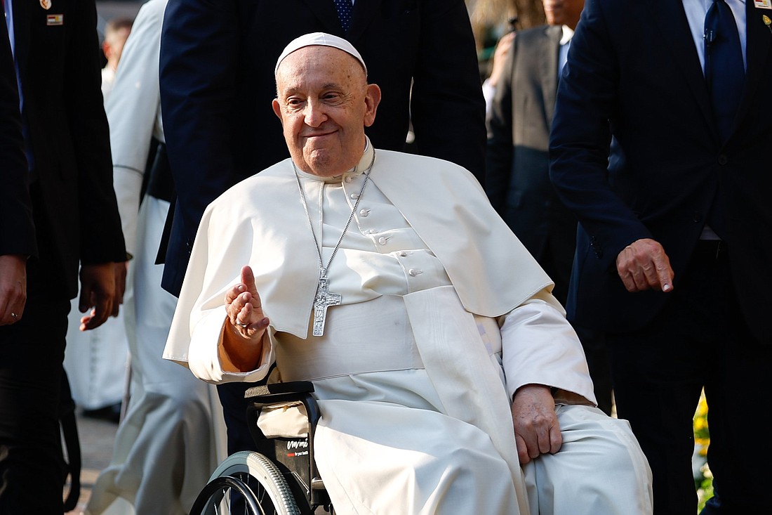 Pope Francis greets the faithful outside the Cathedral of Our Lady of the Assumption before a meeting with bishops, priests, deacons, religious, seminarians and pastoral workers in Jakarta, Indonesia, Sept. 4, 2024. (CNS photo/Lola Gomez)