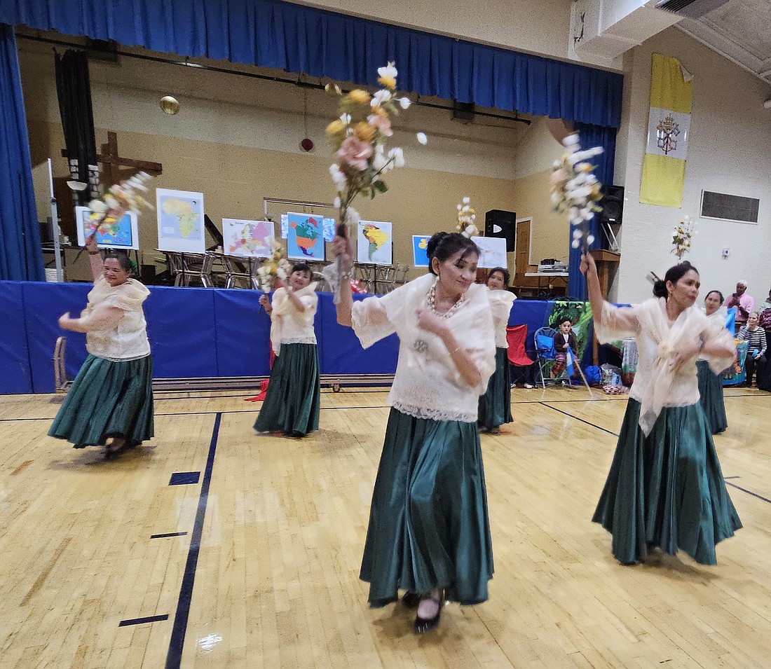 A group of Filipino parishioners perform a traditional dance during the Multicultural Festival. Mary Stadnyk photo