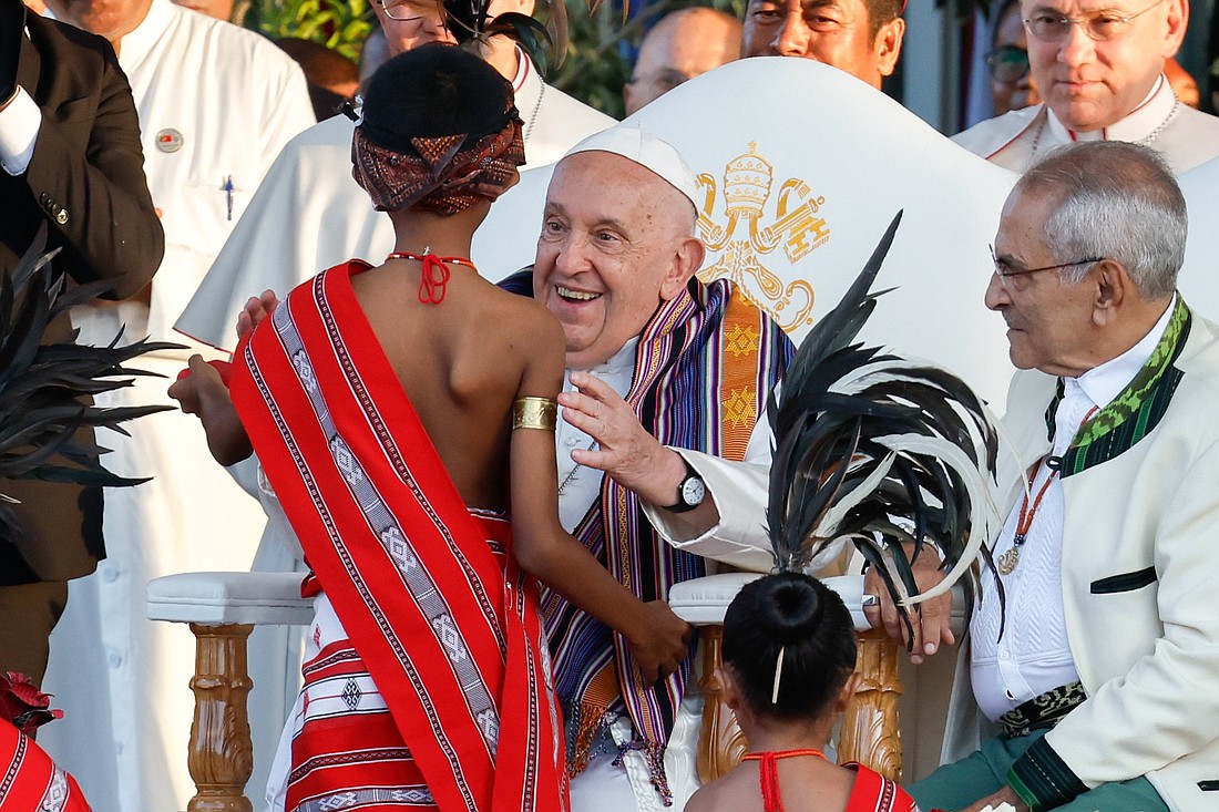 Pope Francis greets a child in traditional dress during a welcome ceremony at the presidential palace in Dili, Timor-Leste, Sept. 9, 2024. (CNS photo/Lola Gomez)