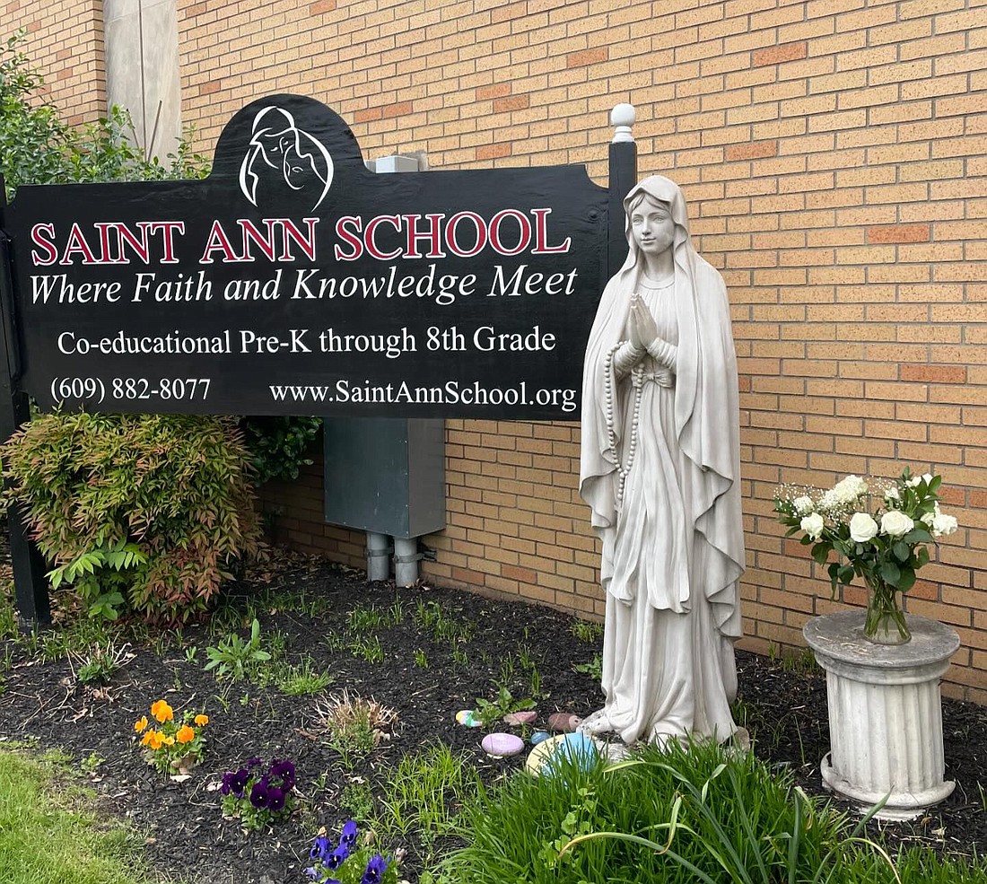 A statue of the Blessed Virgin Mary stands next to a sign on the campus of St. Ann School, Lawrenceville, which marks its 60th anniversary this year. A number of schools reported events planned and new initiatives taking place in the new school year. Courtesy photo