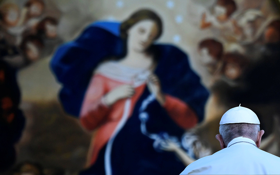 Pope Francis, seated before an image of Our Lady, Undoer of Knots, leads an evening Marian prayer service in the Vatican Gardens May 31, 2021. (CNS photo/Filippo Monteforte, Reuters pool)