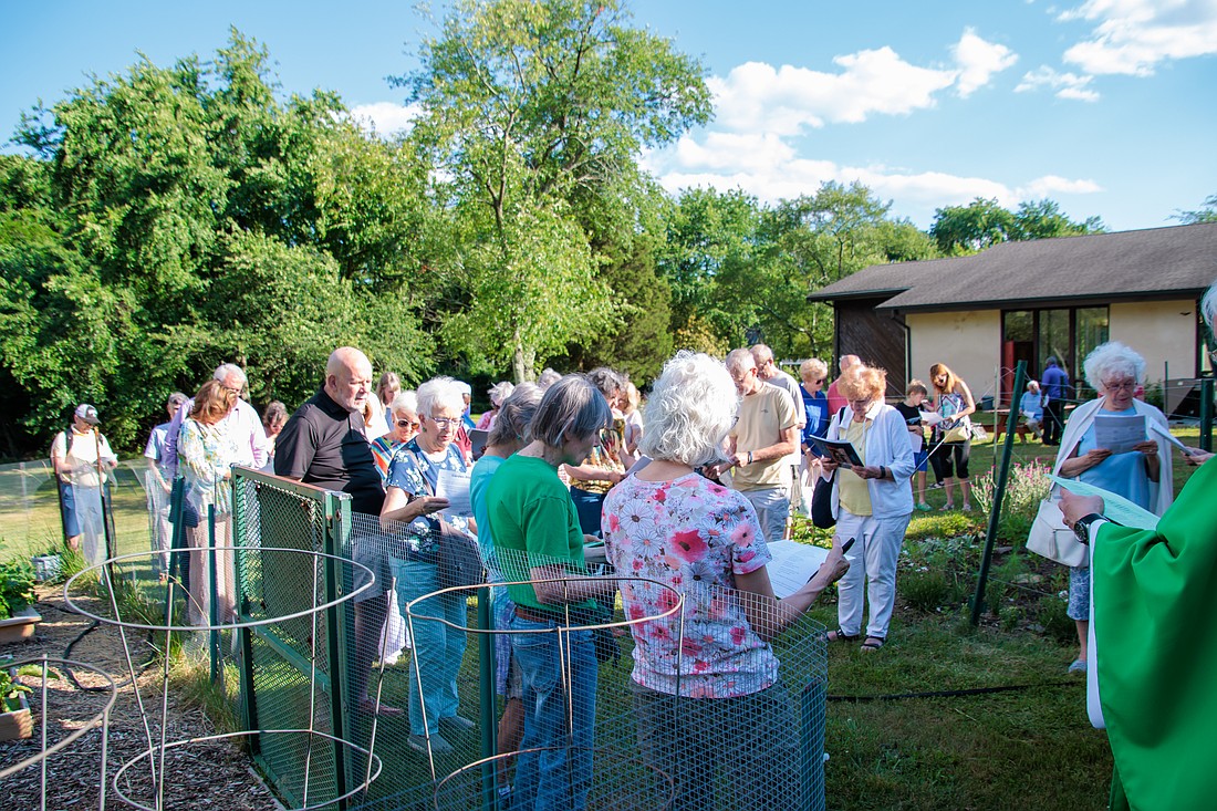 Father Brian T. Butch, pastor of St. Anselm Parish, Tinton Falls, leads parishioners in blessing the St. Anselm Community Garden on June 15. Courtesy photo