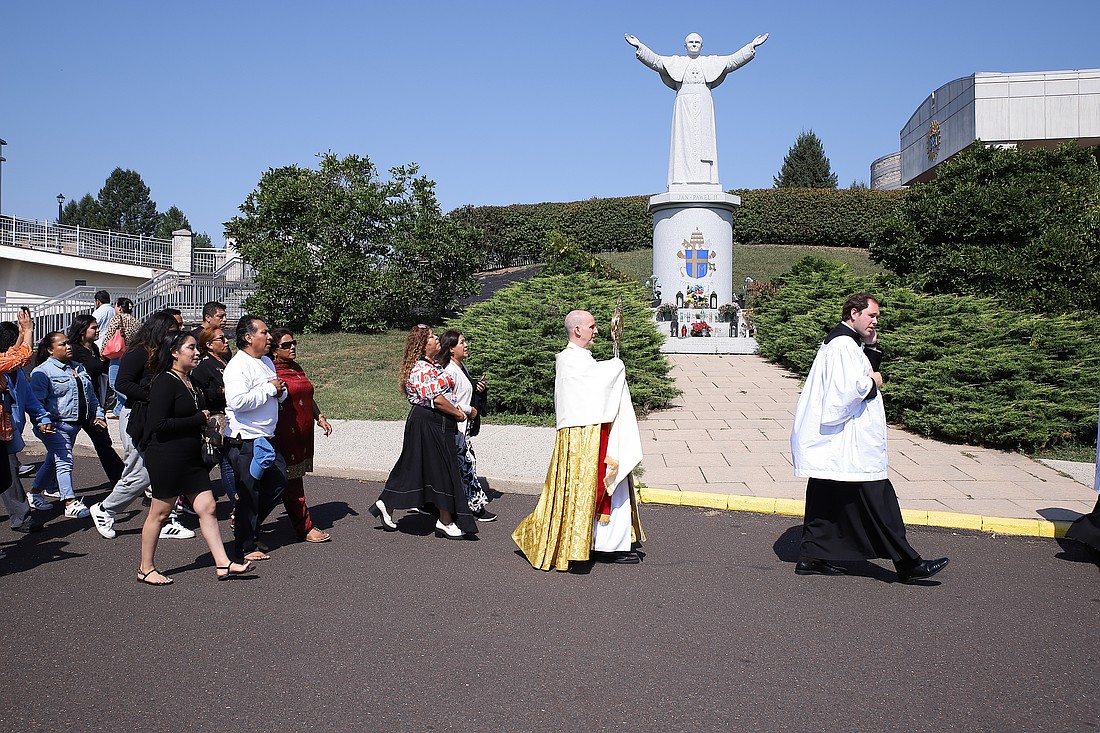 Father Alberto Tamayo carries the Blessed Sacrament as he leads a procession around the grounds of the Shrine of Our Lady of Czestochowa, Doylestown, Pa., Sept. 14. John Batkowski photo