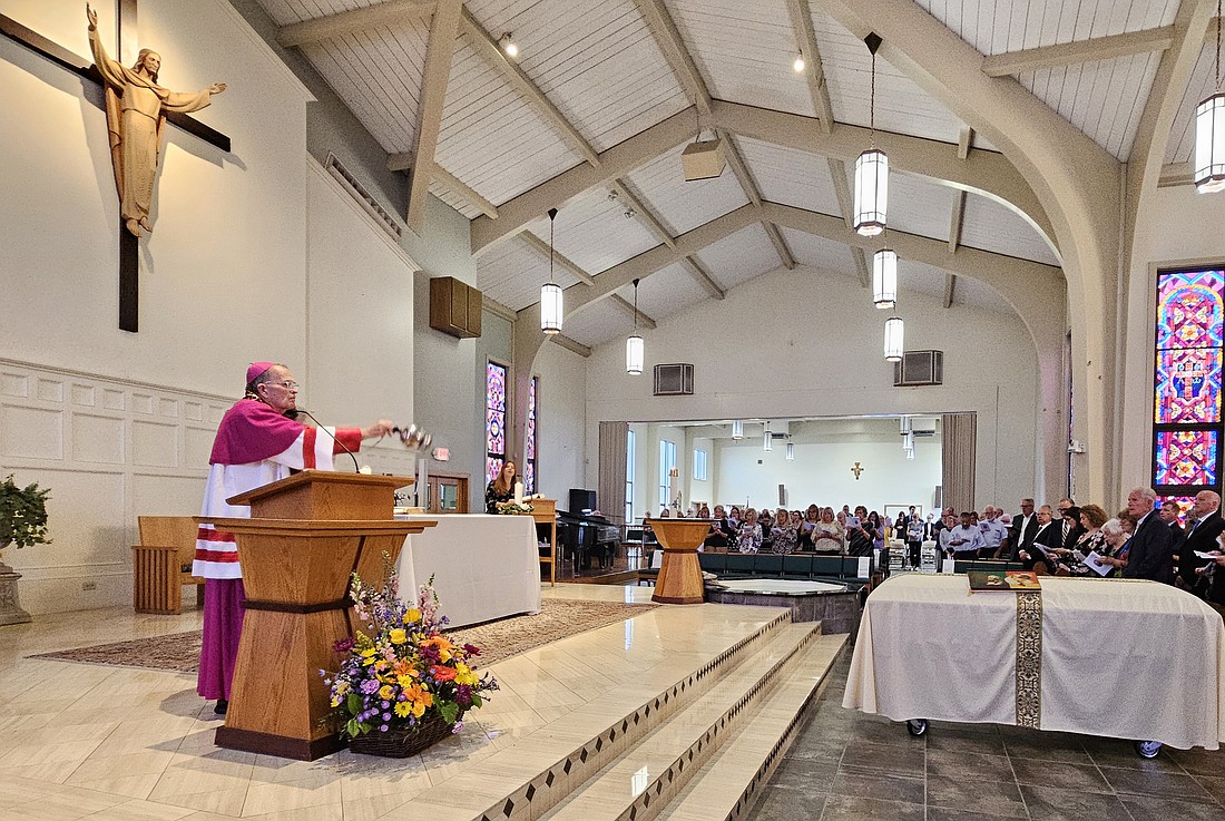 As he leads the Final Commendation, Bishop O'Connell incenses the casket of Franciscan Father John Frambes. Mary Stadnyk photo