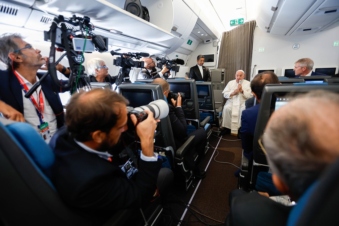 Pope Francis answers a question from a journalist aboard his flight back to Rome Sept. 13, 2024, after visiting Indonesia, Papua New Guinea, Timor-Leste and Singapore. It was his 45th and longest foreign trip. (CNS photo/Lola Gomez)