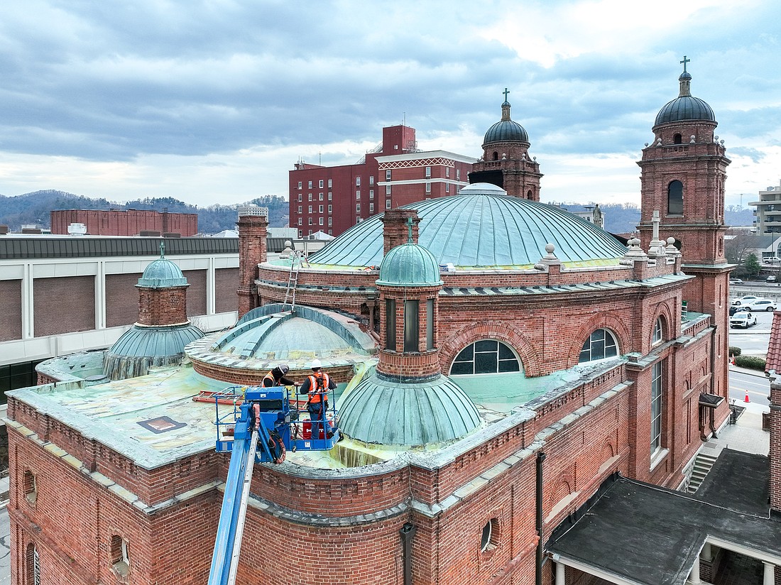 Workers on a cherry picker are pictured in an undated photo surveying the domed roof of the historic St. Lawrence Basilica in downtown Asheville, N.C., in the Charlotte Diocese. On Aug., 20, 2024, the National Park Service announced it was awarding the century-old church a $750,000 "Save America's Treasures" grant, which will be used in a multi-phase project to fully restore the basilica at an estimated cost of $23 million. (OSV News photo/courtesy St. Lawrence Basilica)