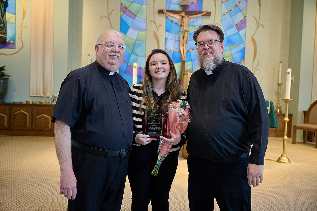 Lisa Ann Limongello is congratulated by the two pastors of the parishes where she serves as parish catechetical leader. At left is Father Stephen Sansevere, pastor of the Catholic Community of Hopewell Valley parishes -- St. James, Pennington; St. Alphonsus, Hopewell, and St. George, Titusville. At right is Father Michael Kennedy, pastor of St. Luke Parish, Toms River. Mike Ehrmann photo