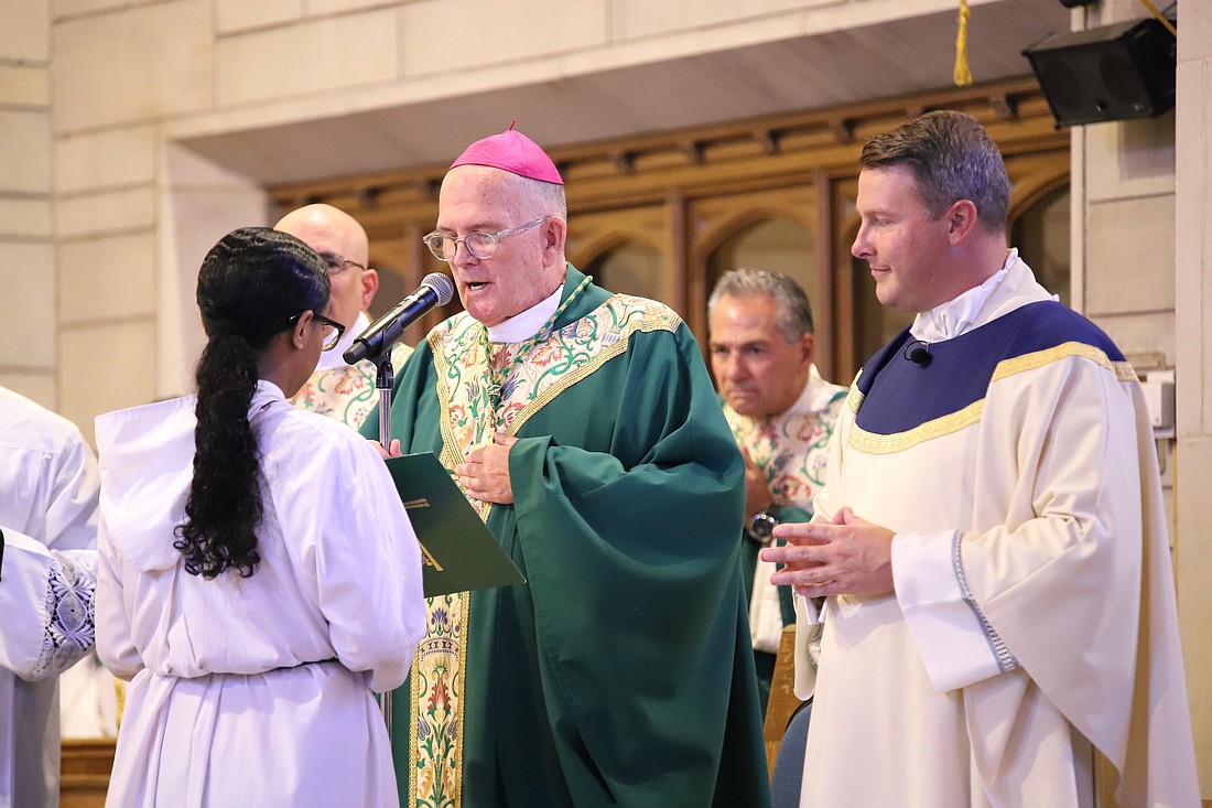 Father Christopher Dayton, right, was installed as pastor of St. Paul Parish, Princeton, during a Sept. 22 Mass celebrated by Bishop David M. O'Connell, C.M. John Batkowski photo