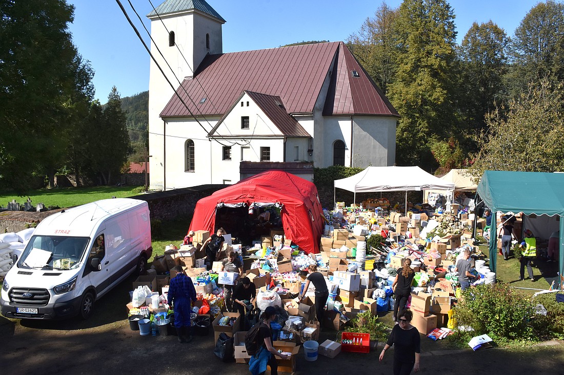 St. Nicholas church in Radochów, Poland, located just 7.5 miles from the collapsed dam in Stronie Slaskie, is seen Sept. 21, 2024. Donated supplies from all over the country are seen in the church's backyard. Torrential rains of Storm Boris Sept. 13-15 caused record floods in picturesque southwestern Poland tourist towns. (OSV News photo/Agnieszka Bugala)