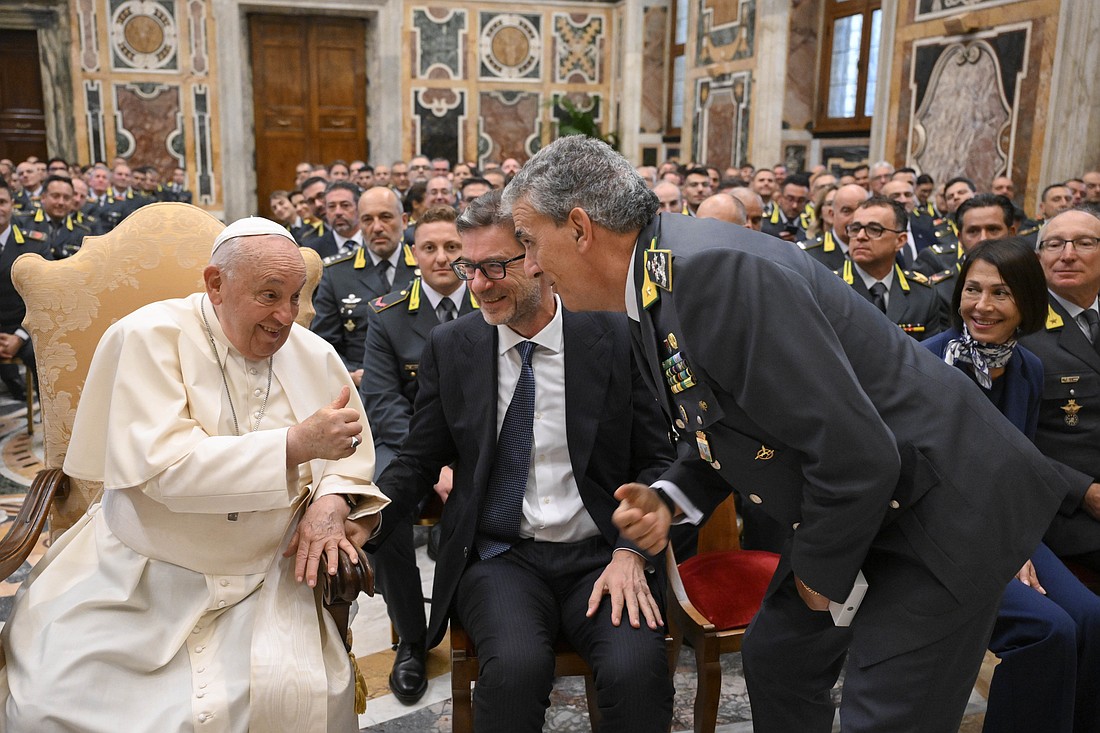 Pope Francis gives a thumbs up to Giancarlo Giorgetti, Italy's minister of economy and finance, and Gen. Andrea De Gennaro, commandant of Italy's Guardia di Finanza, the financial police, in the Clementine Hall of the Apostolic Palace at the Vatican Sept. 21, 2024. (CNS photos/Vatican Media)