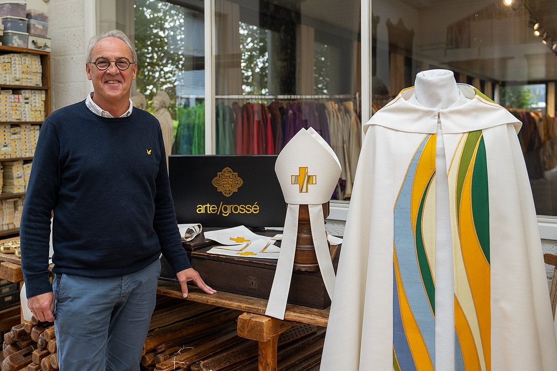 Tailor Marc Schotte is pictured in an undated photo with the choir coat and mitre that his company designed for Pope Francis for his Sept. 26-29, 2024, trip to Belgium. (OSV News photo/courtesy Arte Grossé)