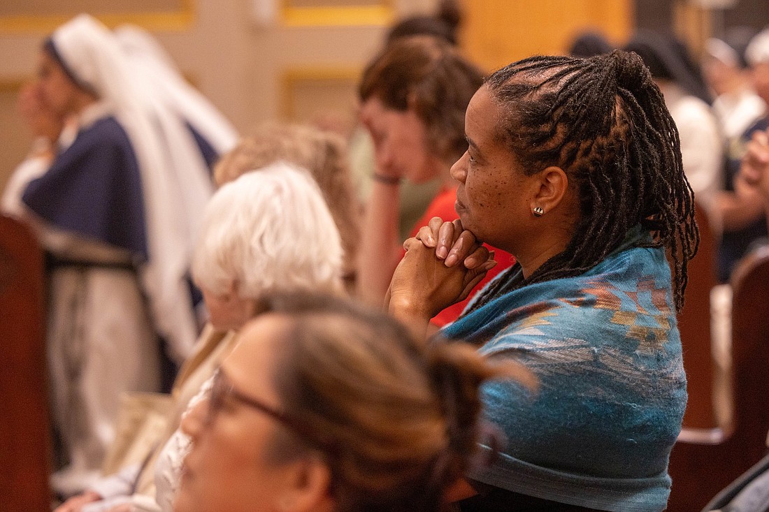 A woman prays during a Mass celebrating the 125th anniversary  of the Franciscan Monastery of the Holy Land in Washington Sept. 22, 2024. (OSV News photo/Mihoko Owada, Catholic Standard)