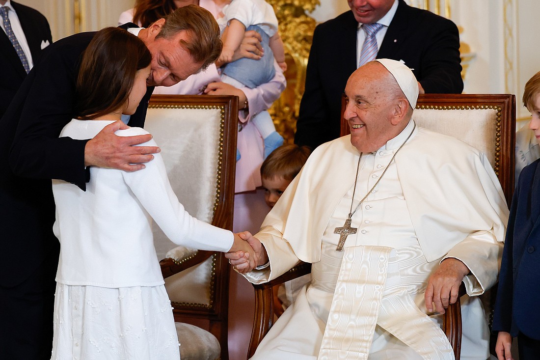 Pope Francis greets one of the granddaughters of Luxembourg's Grand Duke Henri and Grand Duchess Maria Teresa at the Grand Ducal Palace in Luxembourg Sept. 26, 2024. (CNS photo/Lola Gomez)