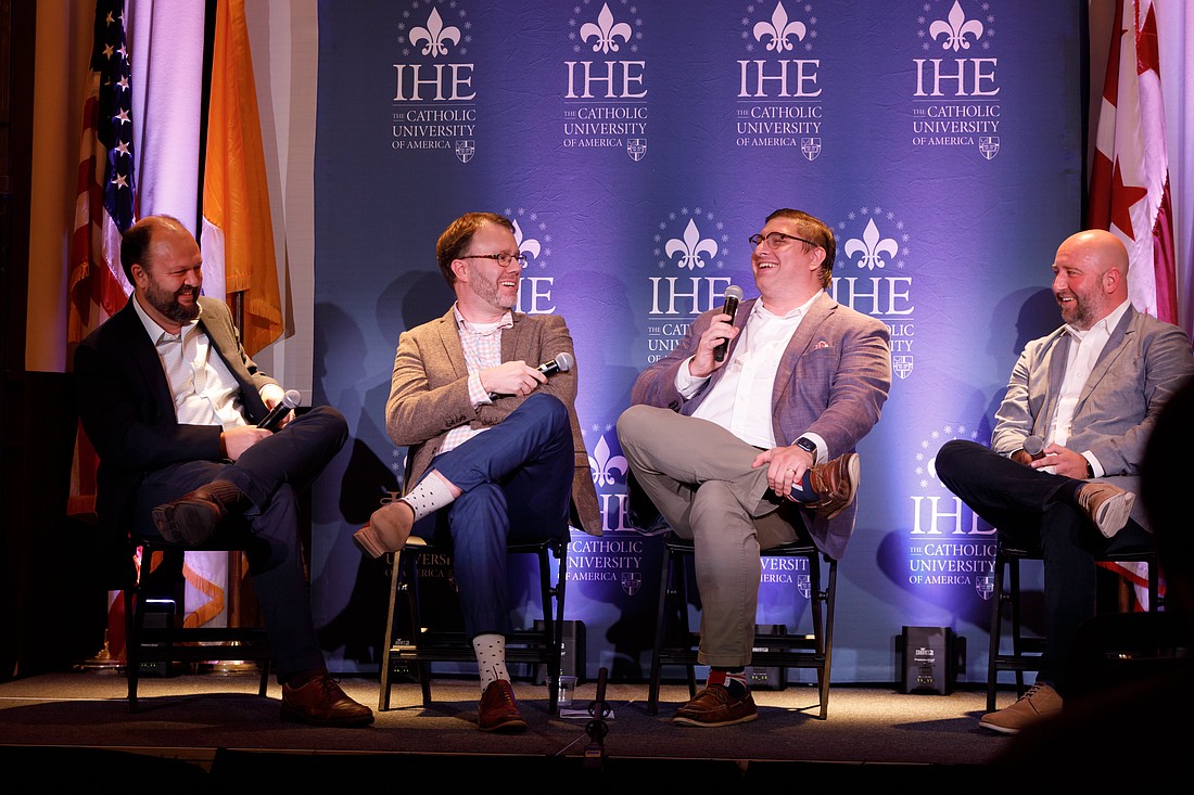 Ross Douthat, a New York Times columnist, Ari Schulman, editor of The New Atlantis, Jonathan D. Askonas, assistant professor of Politics at The Catholic University of America, and Luke Burgis, entrepreneur and author, share a light moment during the "Can Humanity Survive the Digital Age?" event at The Catholic University of America in Washington Sept. 17, 2024. The conversation explored the social and political dimensions of science, technology, culture, and religion. (OSV News photo/Rui Barros, The Catholic University of America)