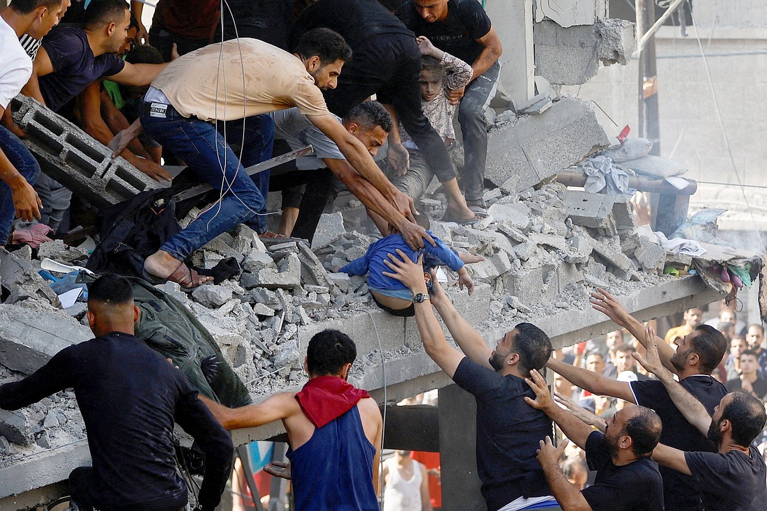 Palestinians attend to a child who was a casualty of an Israeli airstrike on a house in Khan Younis, in the southern Gaza Strip, Oct. 24, 2023. Cardinal Pierbattista Pizzaballa, the Latin patriarch of Jerusalem, released a letter to the faithful Sept. 26, 2024, calling for a day of prayer and penance on the anniversary of the Oct. 7, 2023, attack on Israel by Hamas and the start of the Israel-Hamas war. (OSV News photo/Ibraheem Abu Mustafa, Reuters) Editors: note graphic content..